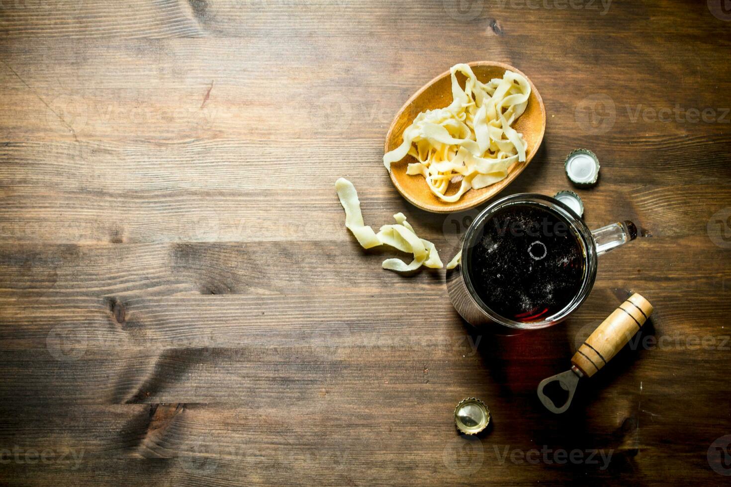Beer in a mug and squid rings in a bowl. photo