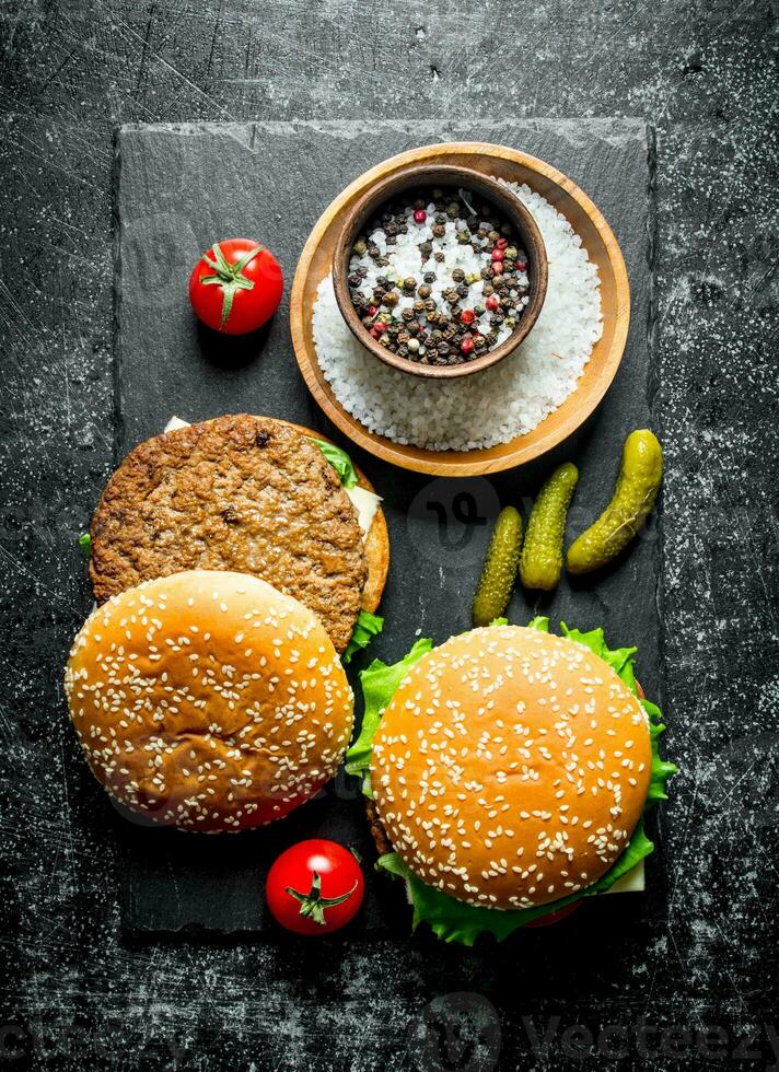Burgers with spices, tomatoes and cucumbers. photo