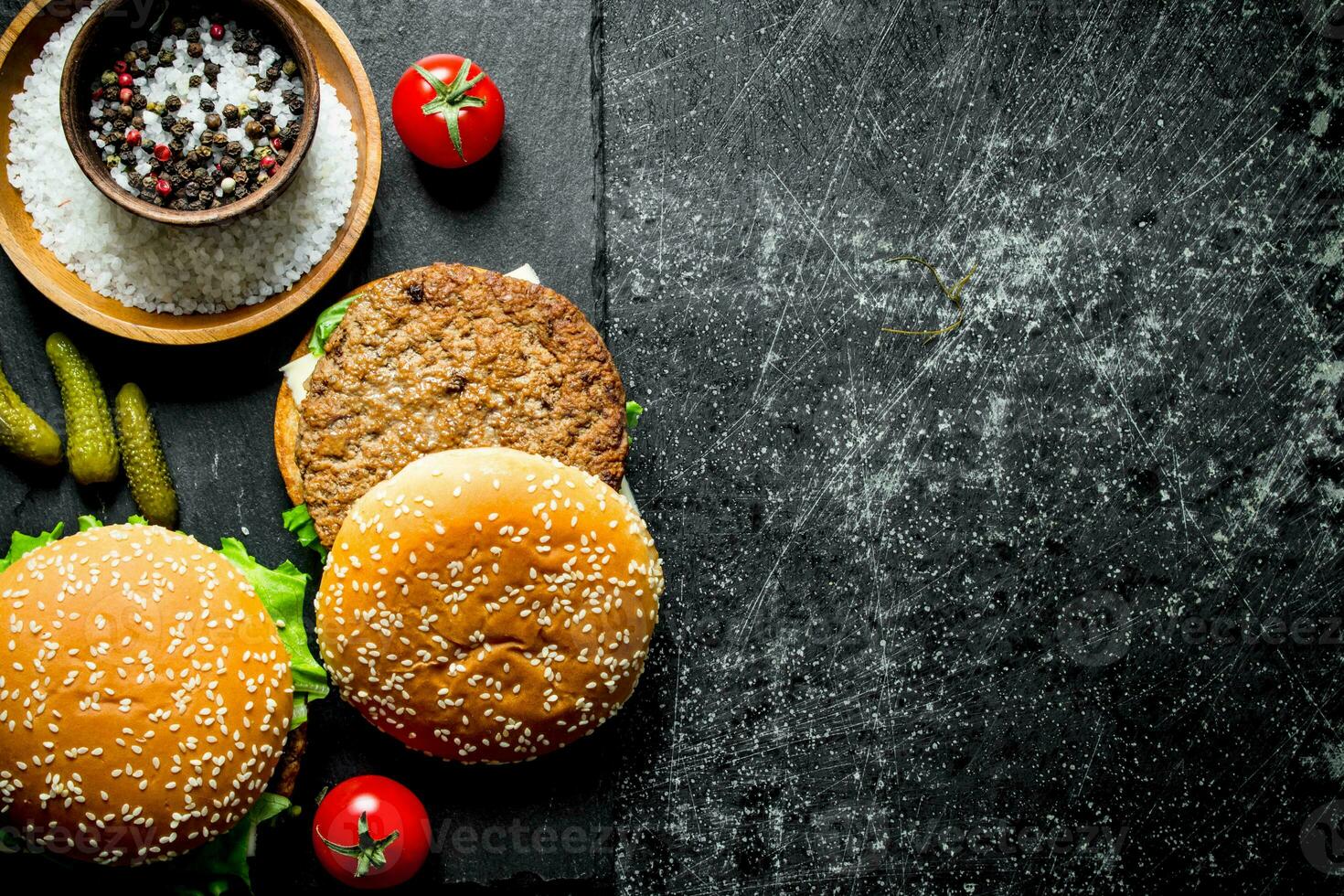 Burgers with spices, tomatoes and cucumbers. photo