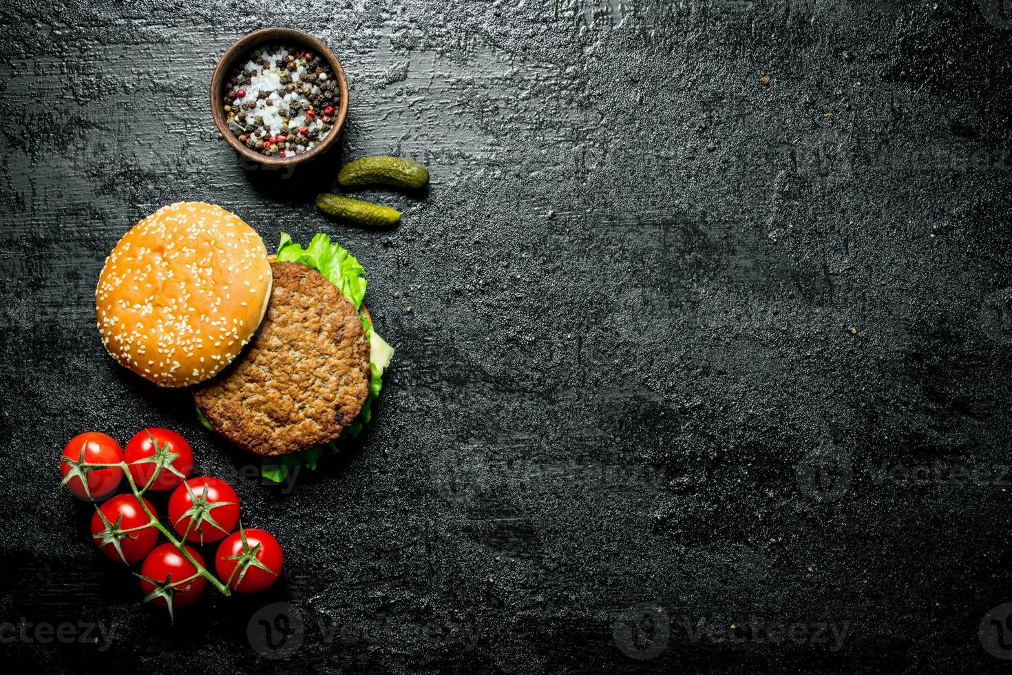 Burger with tomatoes,cucumbers and spices. photo