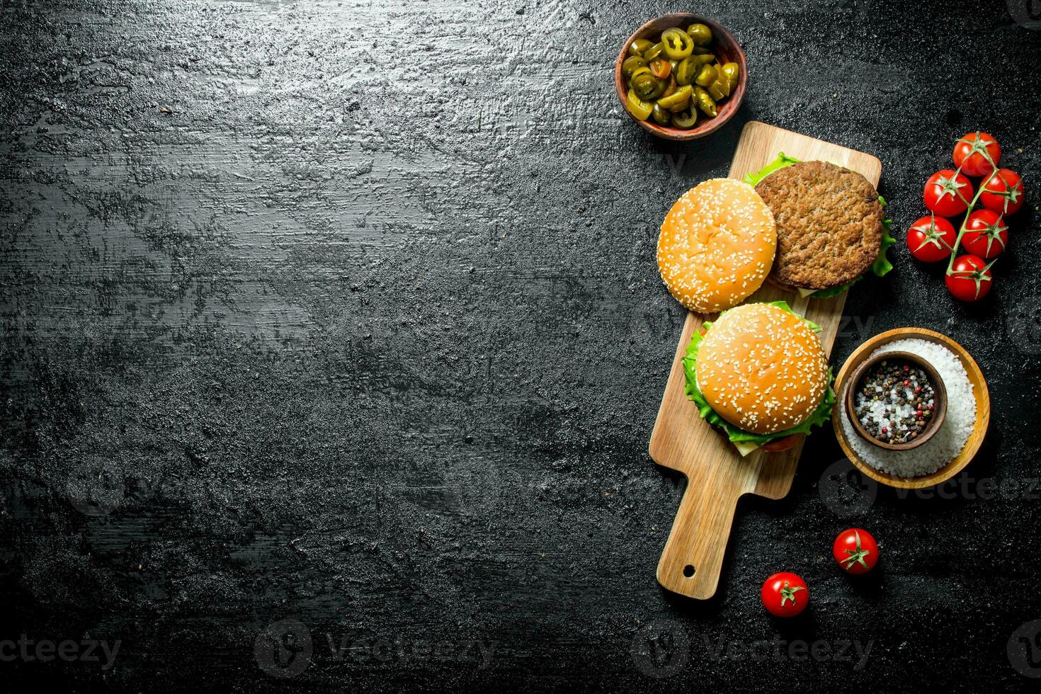 Burgers with jalapeno chillies and tomatoes. photo