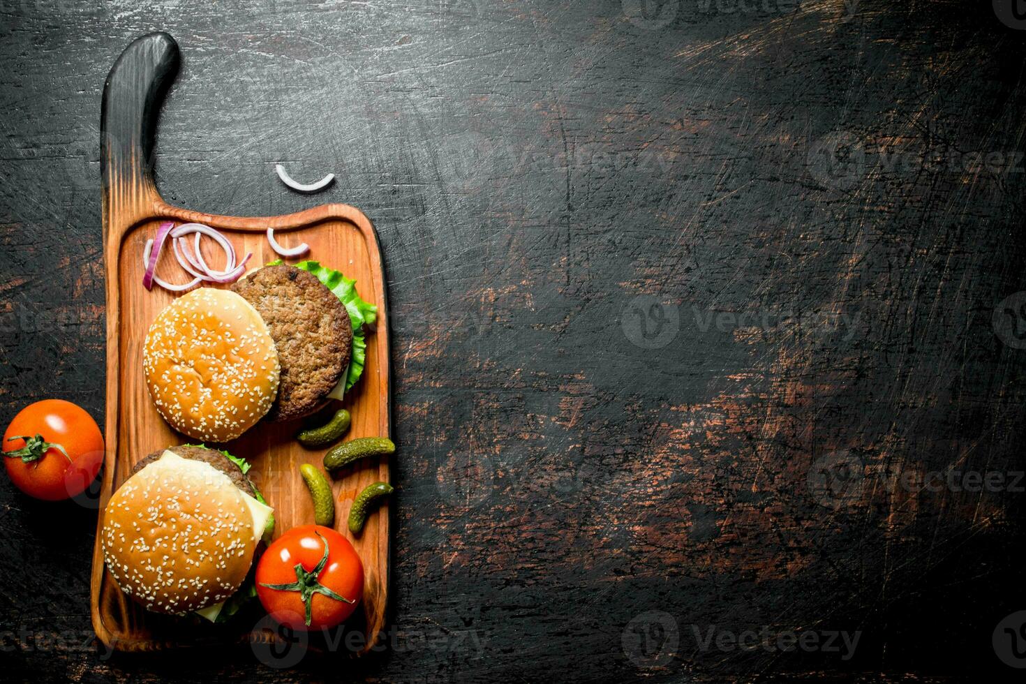 Burgers with gherkins and tomatoes. photo