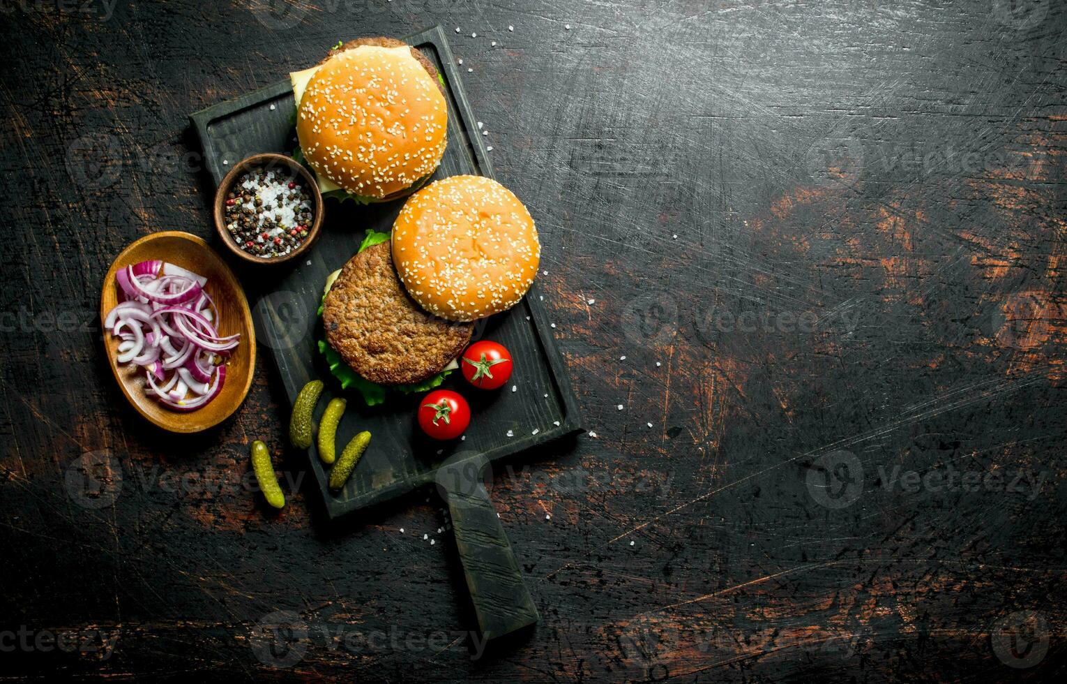 Burgers with spices and chopped onions in bowls. photo