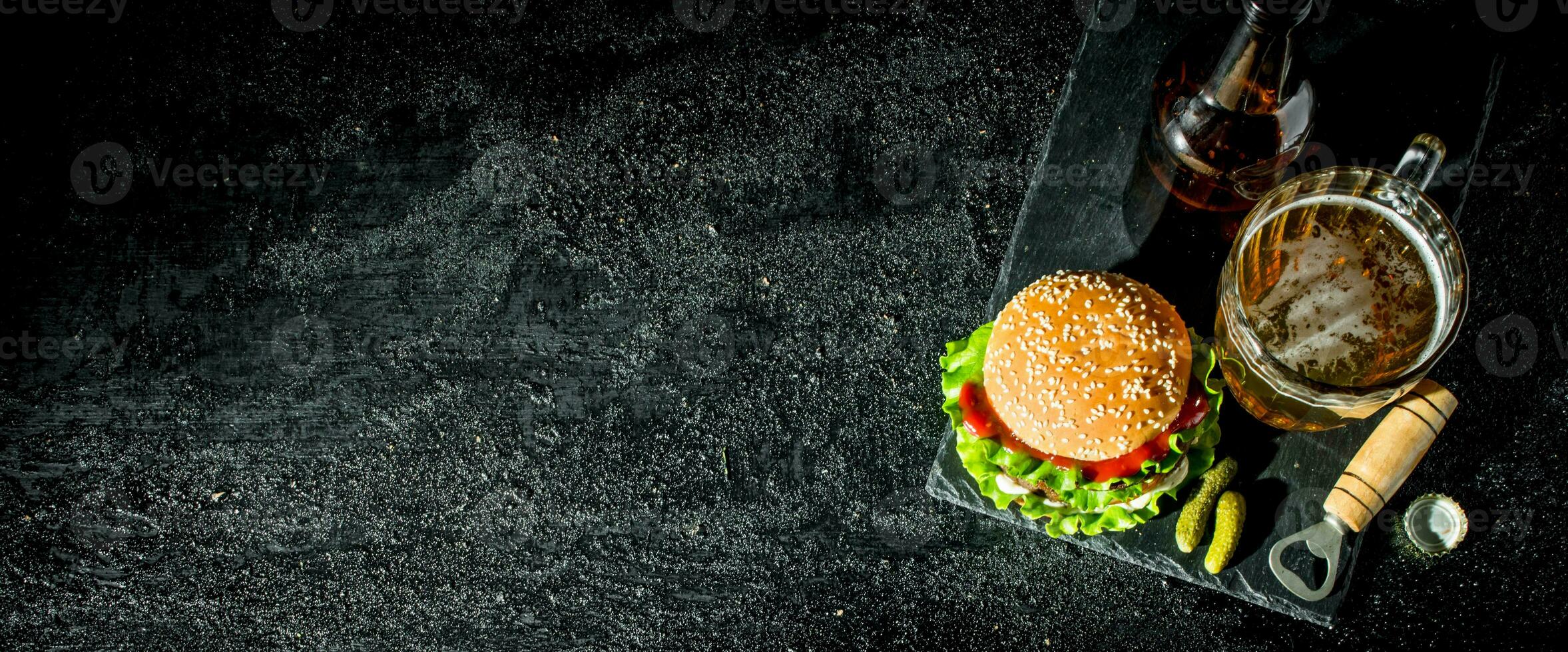 Beef Burger and beer in a glass and bottle. photo