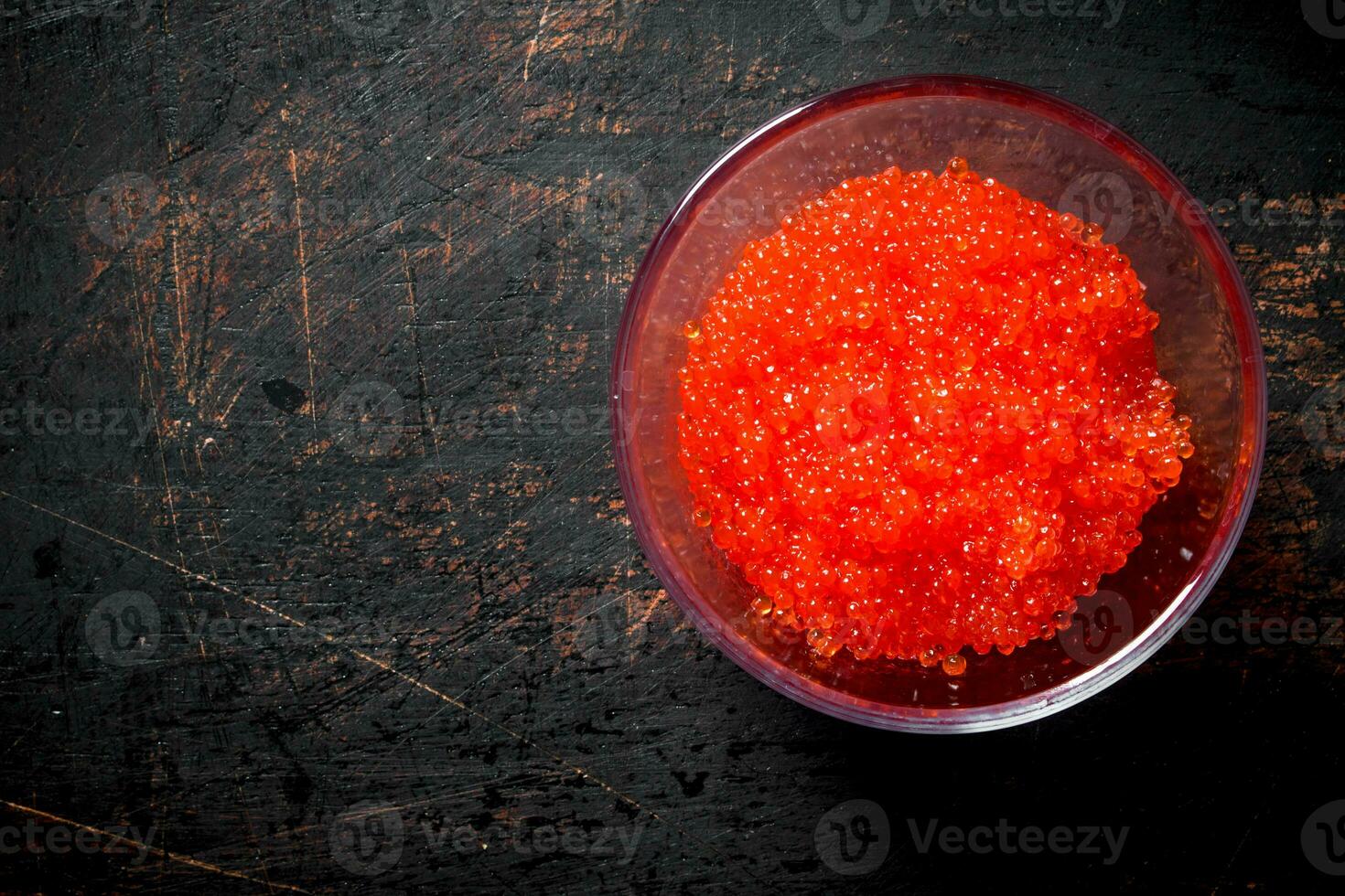 Red caviar in a glass bowl. photo