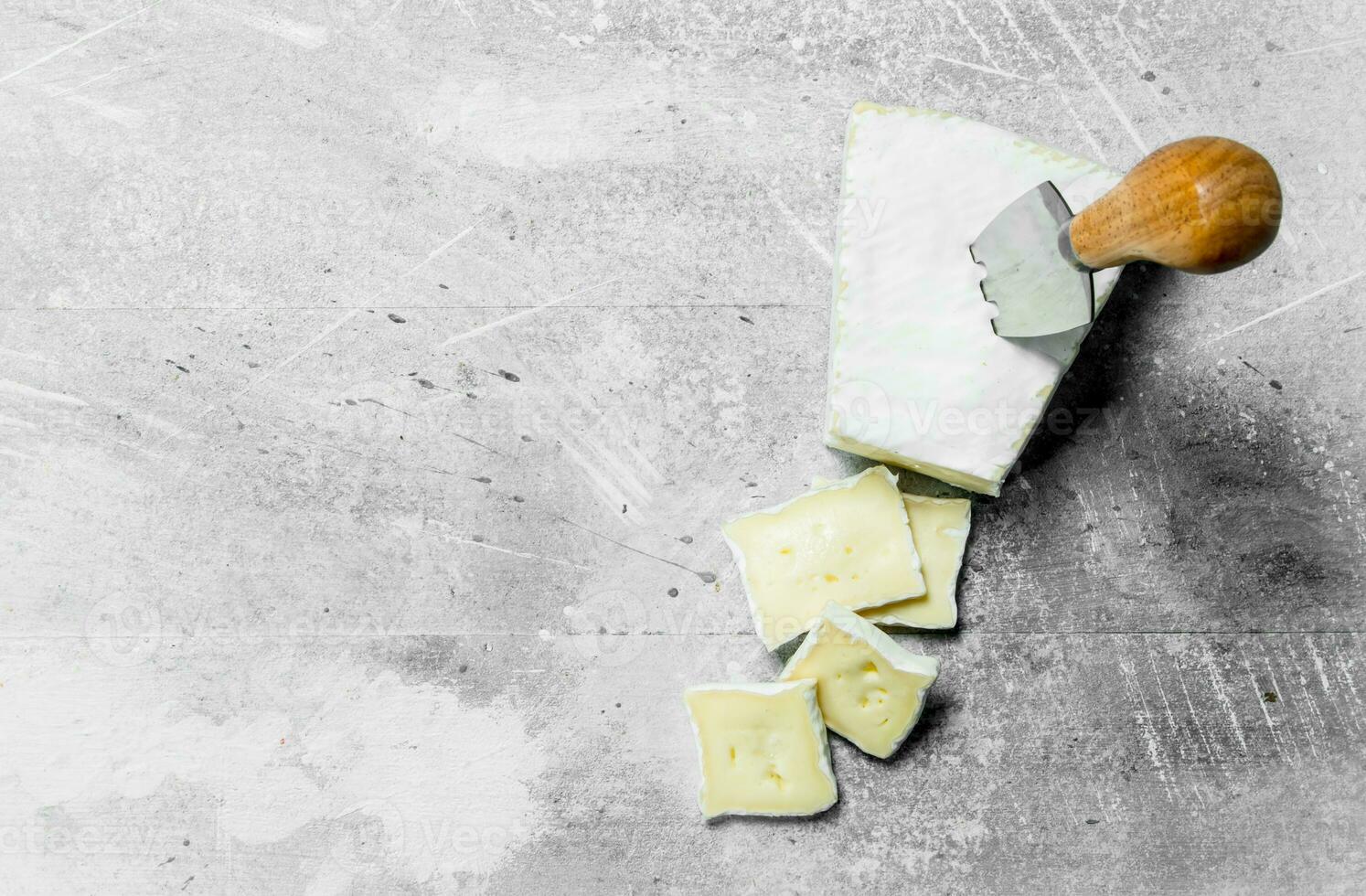 Brie cheese with knife. 32002814 Stock Photo at Vecteezy