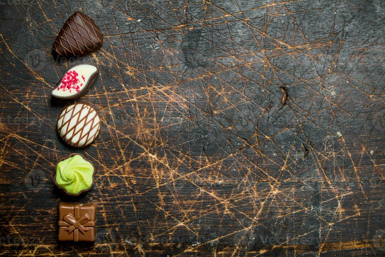 Chocolate sweets with nuts and various fillings. photo
