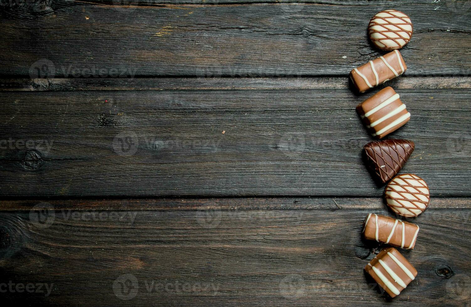 Chocolate sweets with nuts and various fillings. photo