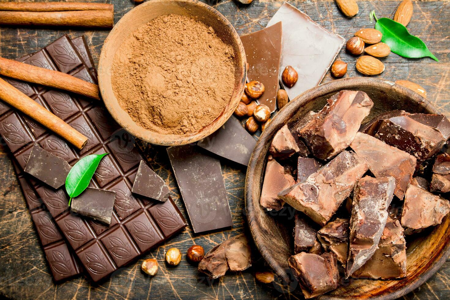 Chocolate background. Chocolate with cocoa powder and cinnamon. photo