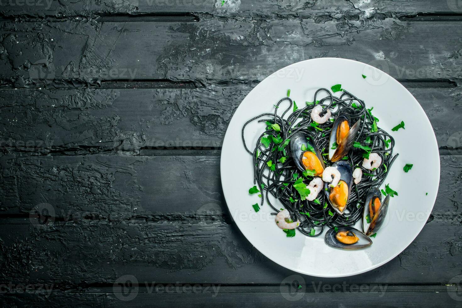 Mediterranean food. Spaghetti with cuttlefish ink and clams. photo