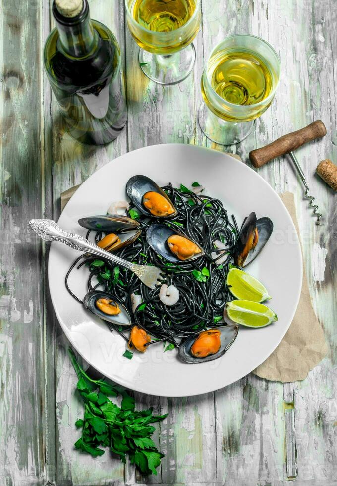 Mediterranean pasta. Spaghetti with cuttlefish ink, clams and white wine. photo