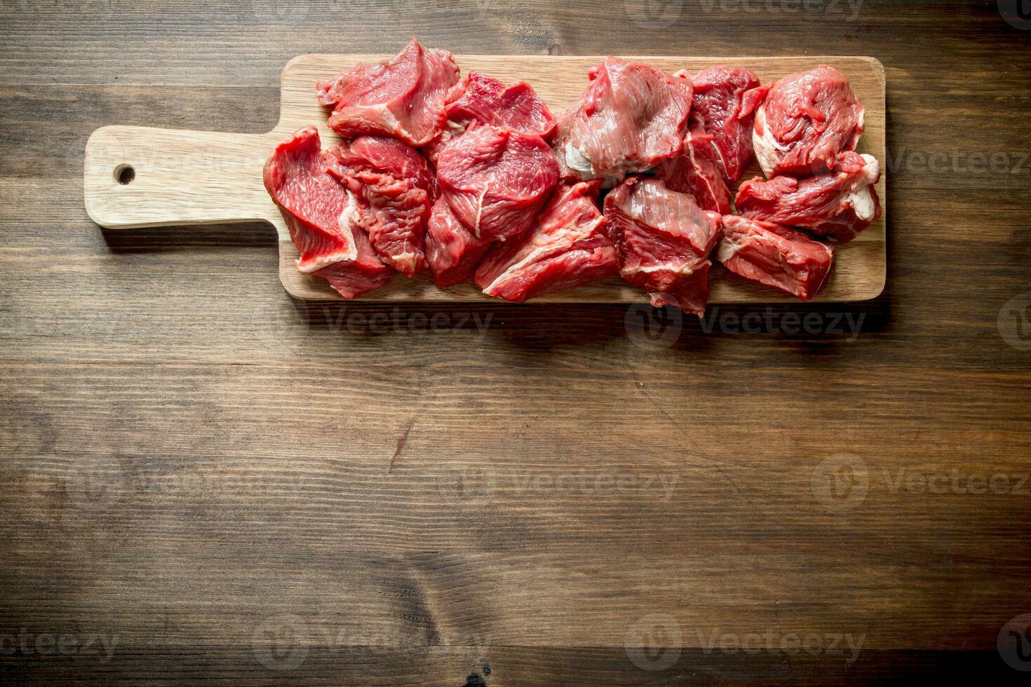 Sliced raw beef on a cutting Board. photo
