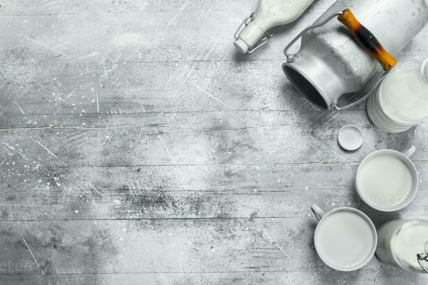 Milk in mugs with a can. photo