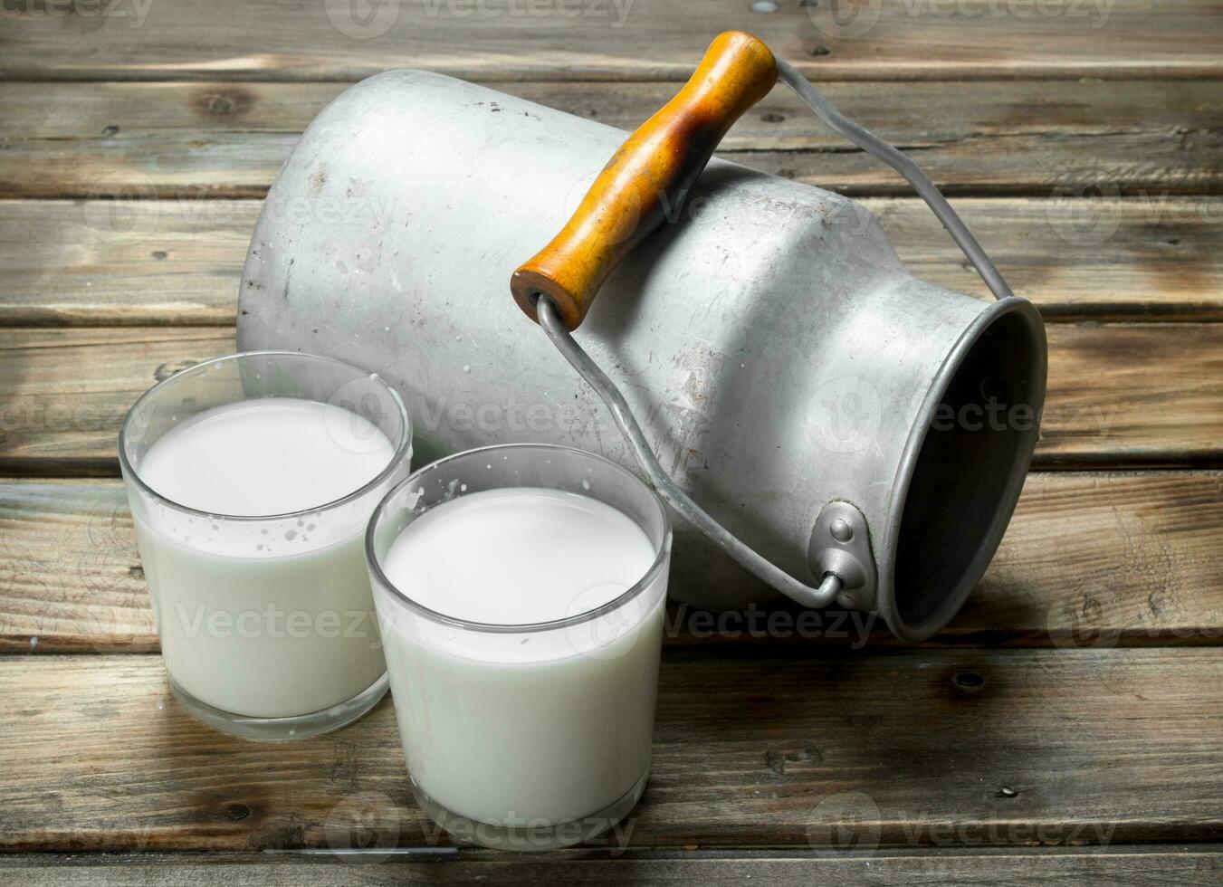 Fresh milk in a glass with a can. photo