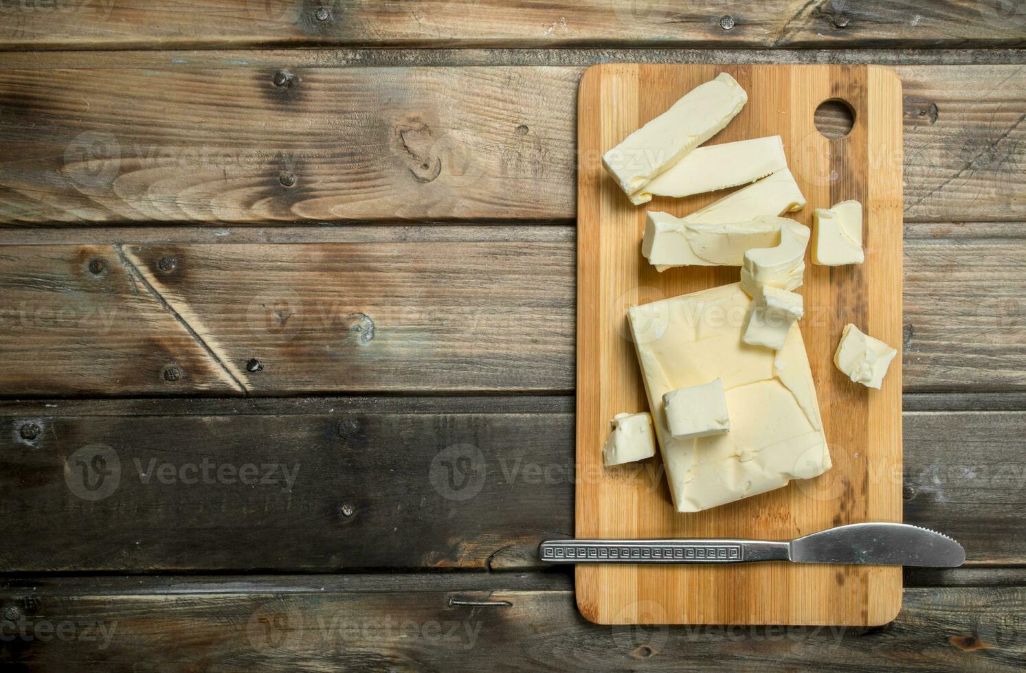 Butter with a knife on the Board. photo