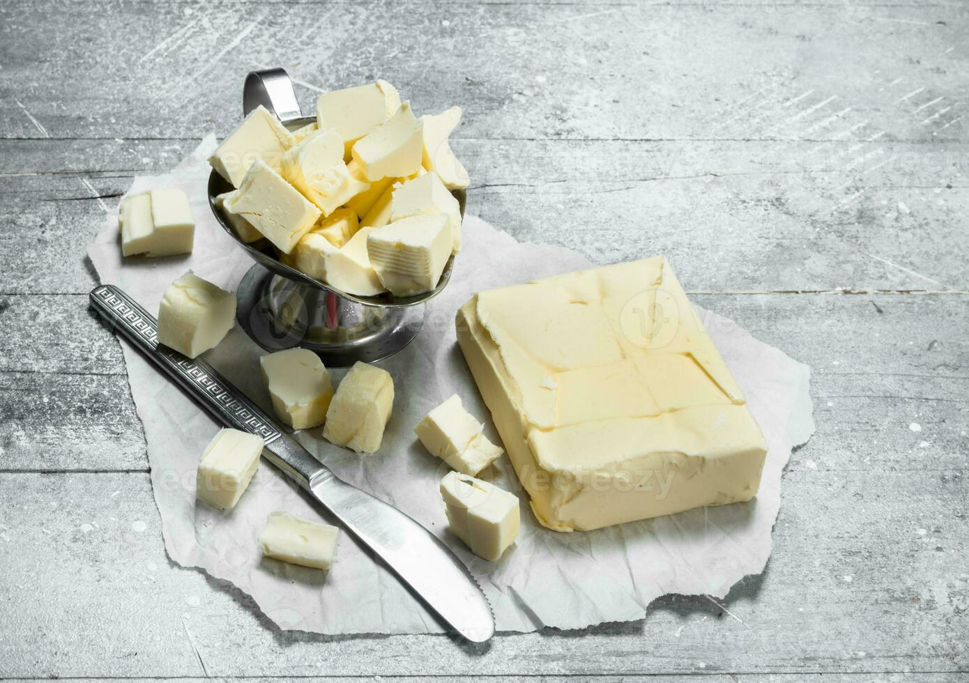 Butter in a bowl with a knife. photo