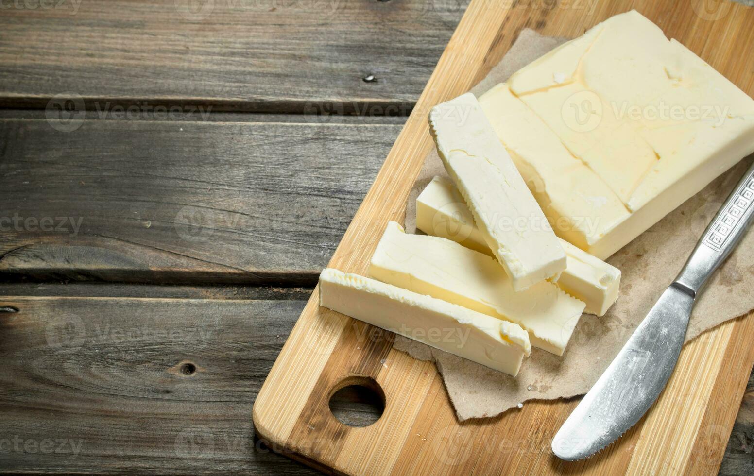 Butter with a knife on the Board. photo