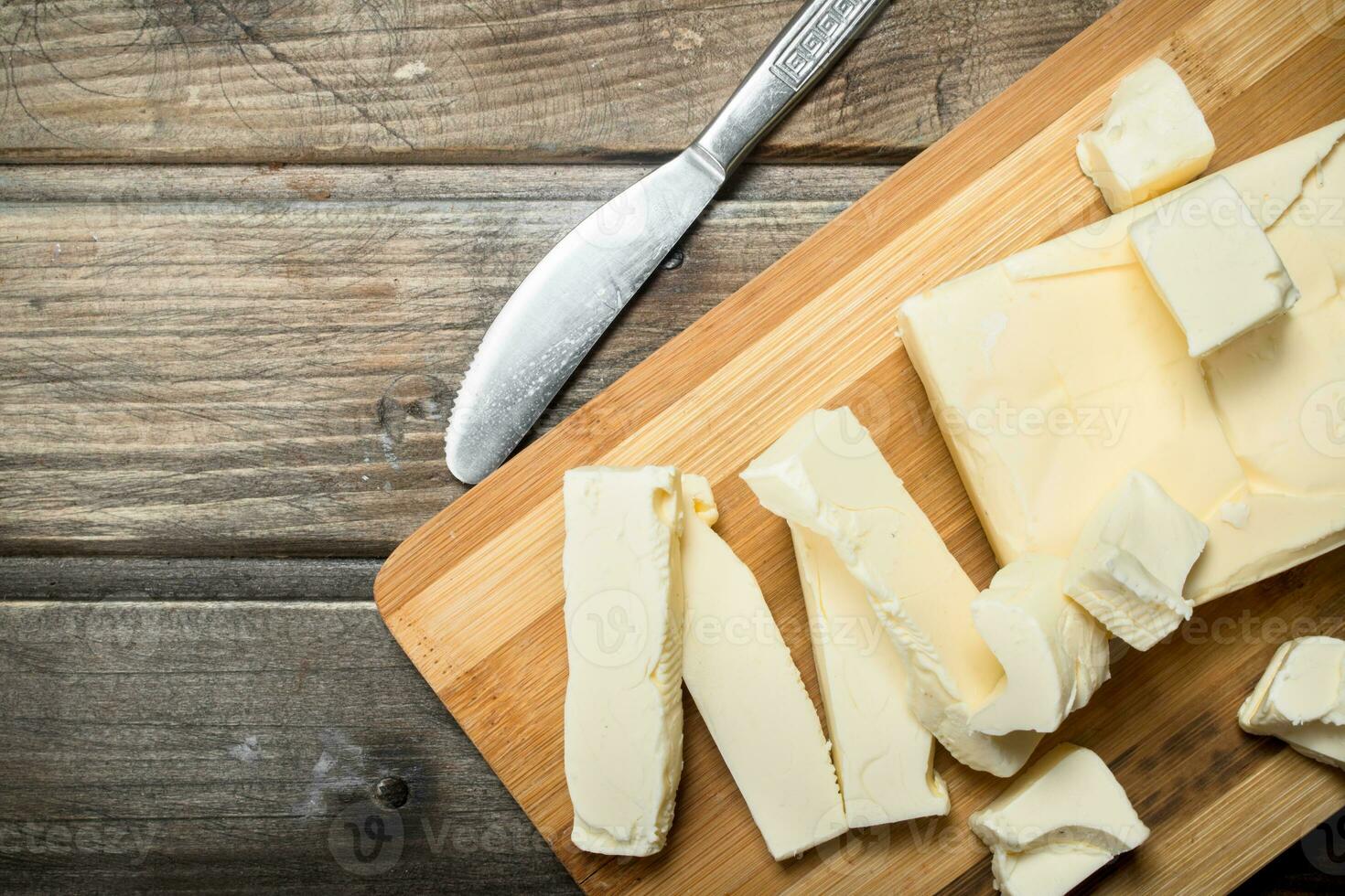 Butter with a knife on the Board. photo