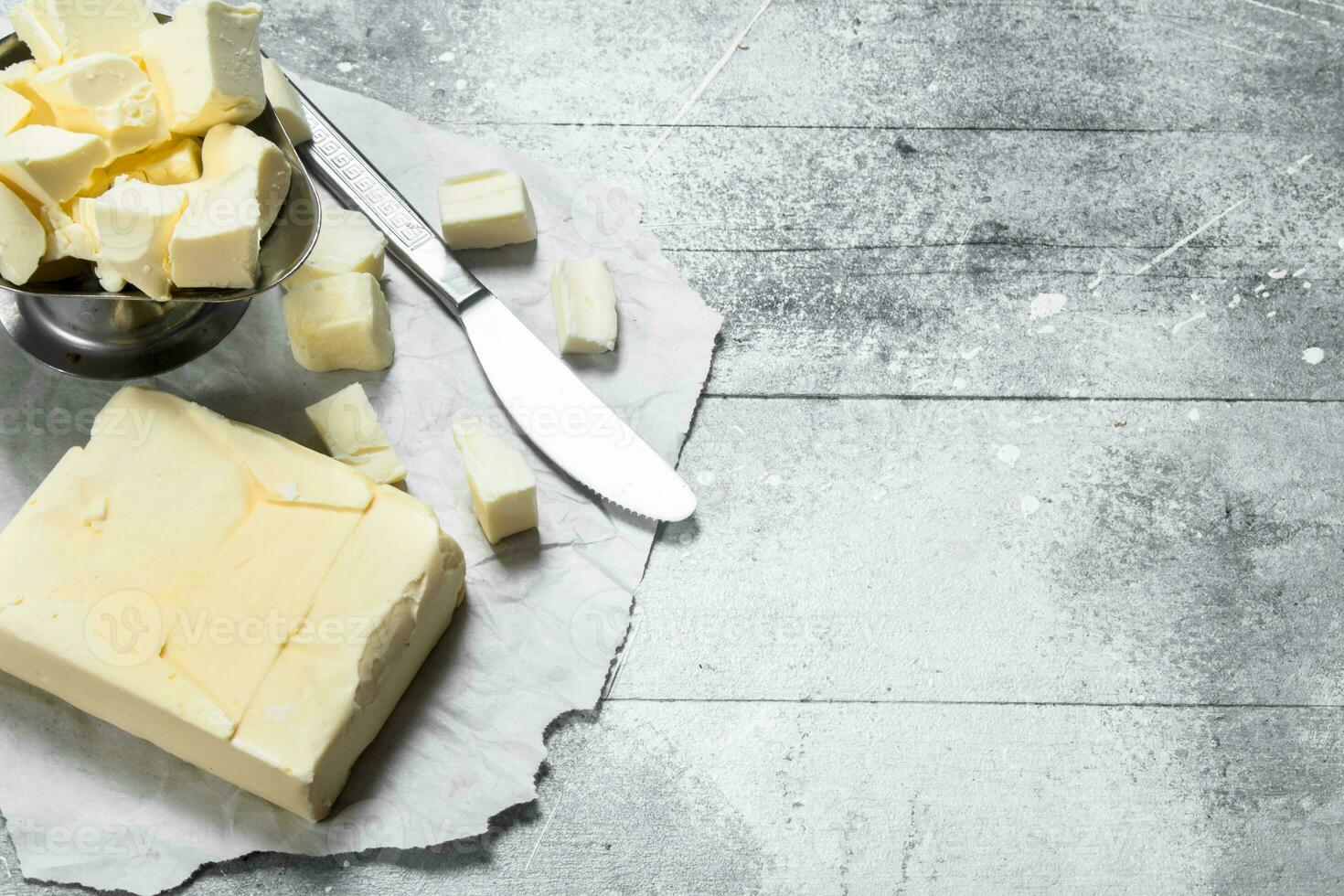Butter in a bowl with a knife. photo
