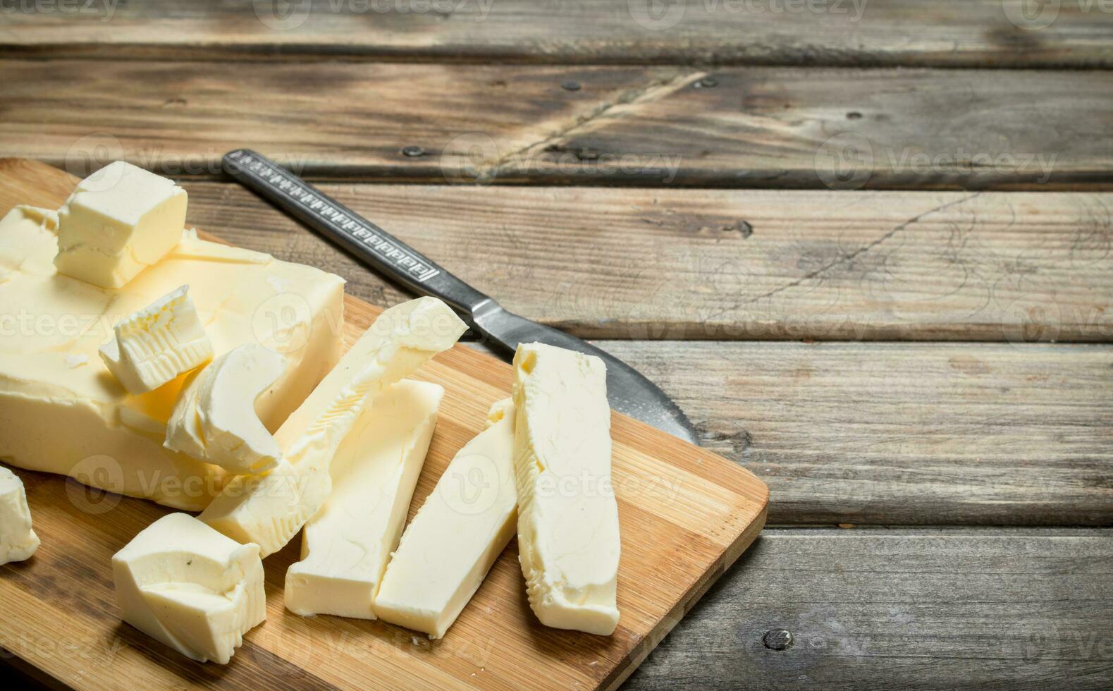 Butter with a knife on the Board. photo