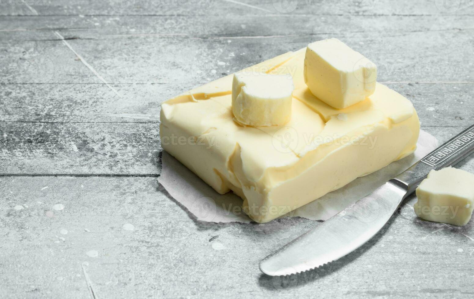 Butter on paper with a knife photo
