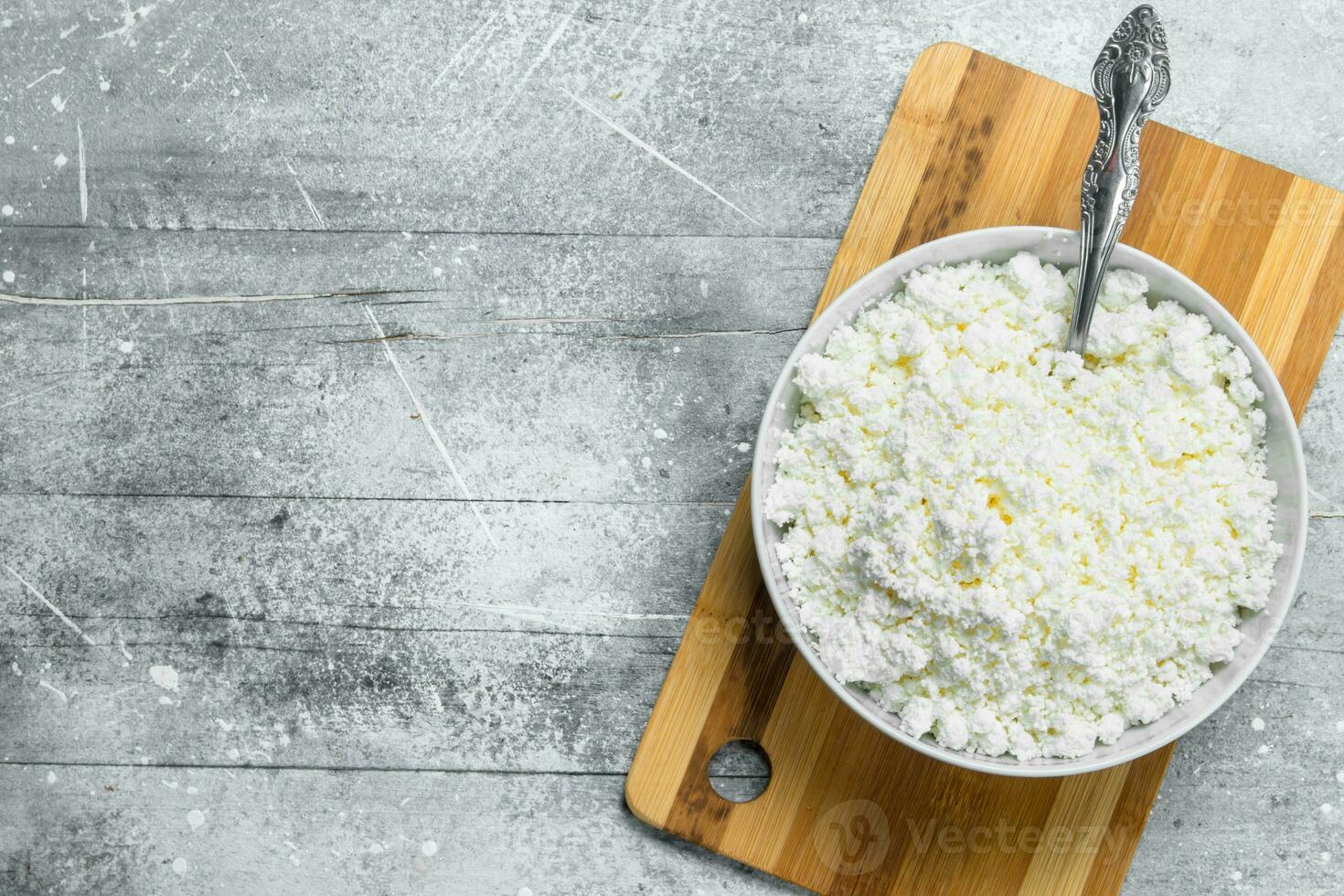 Cottage cheese in a bowl with a spoon. photo