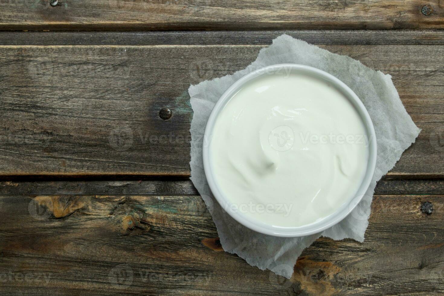 Fresh sour cream in bowl . photo