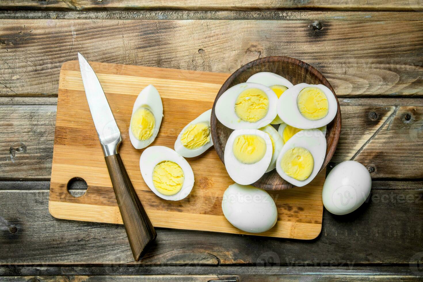 Sliced boiled eggs on cutting board. photo