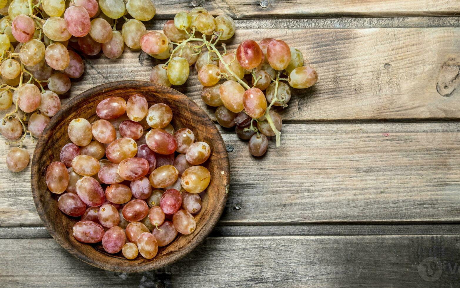 Pink grapes in bowl . photo