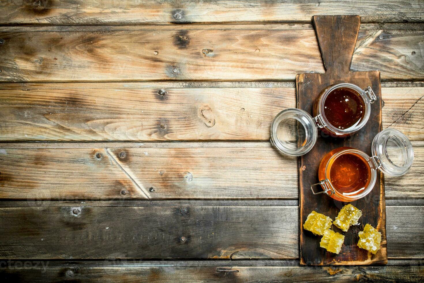 Bee honey on an old Board. photo