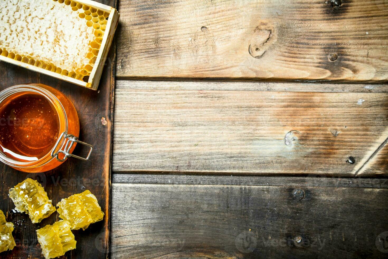 Bee honey on an old Board. photo