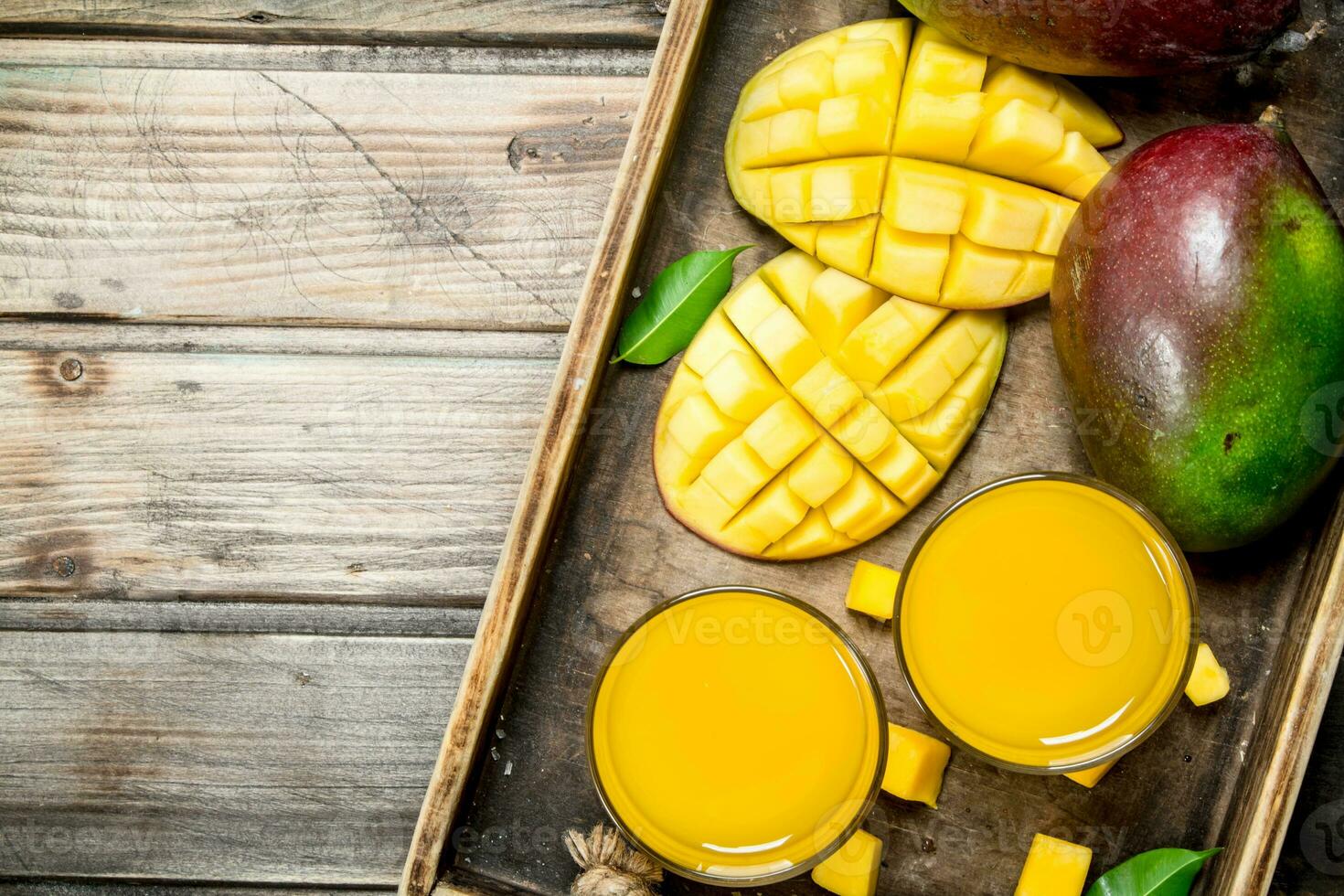 Mango juice in a glass on tray. photo