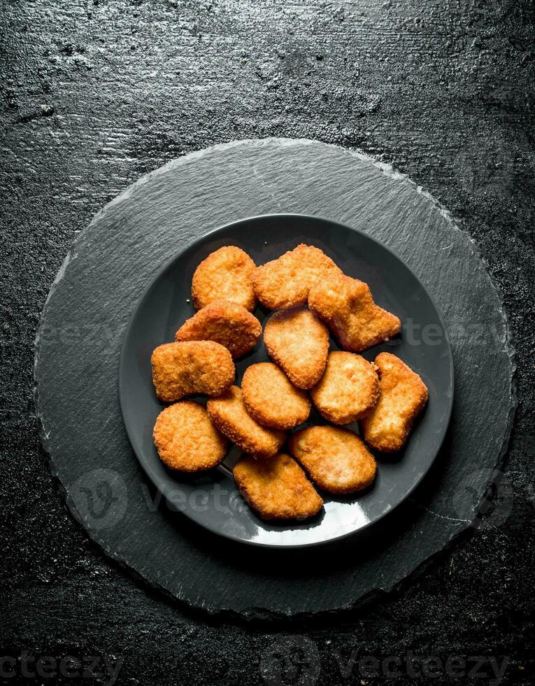 Chicken nuggets on the plate. photo