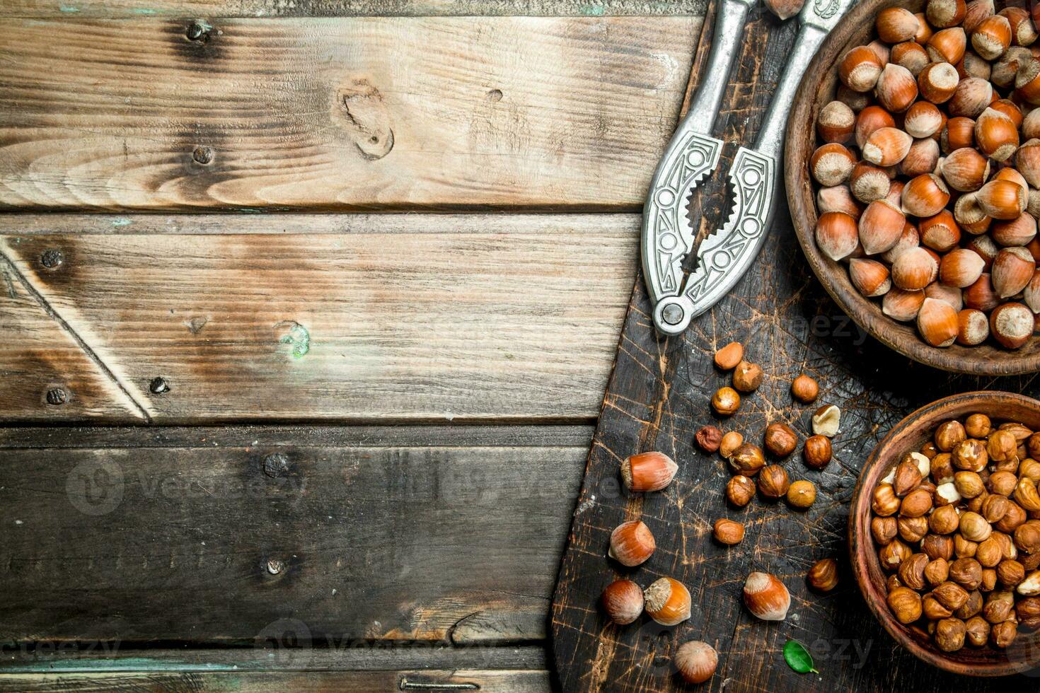 Hazelnuts with Nutcracker on the old Board . photo