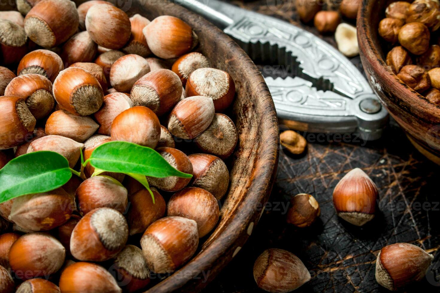 Hazelnuts with Nutcracker on the old Board . photo