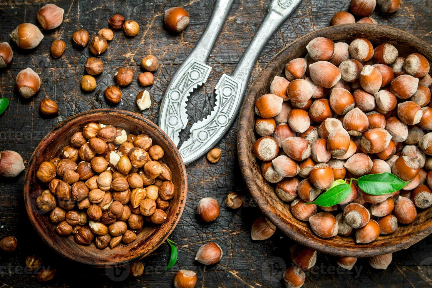 Hazelnuts with Nutcracker on the old Board . photo
