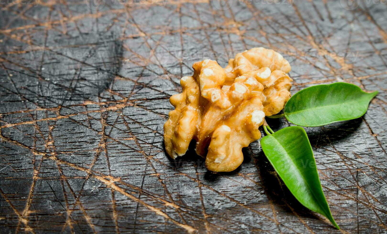 Shelled walnut with green leaves. photo