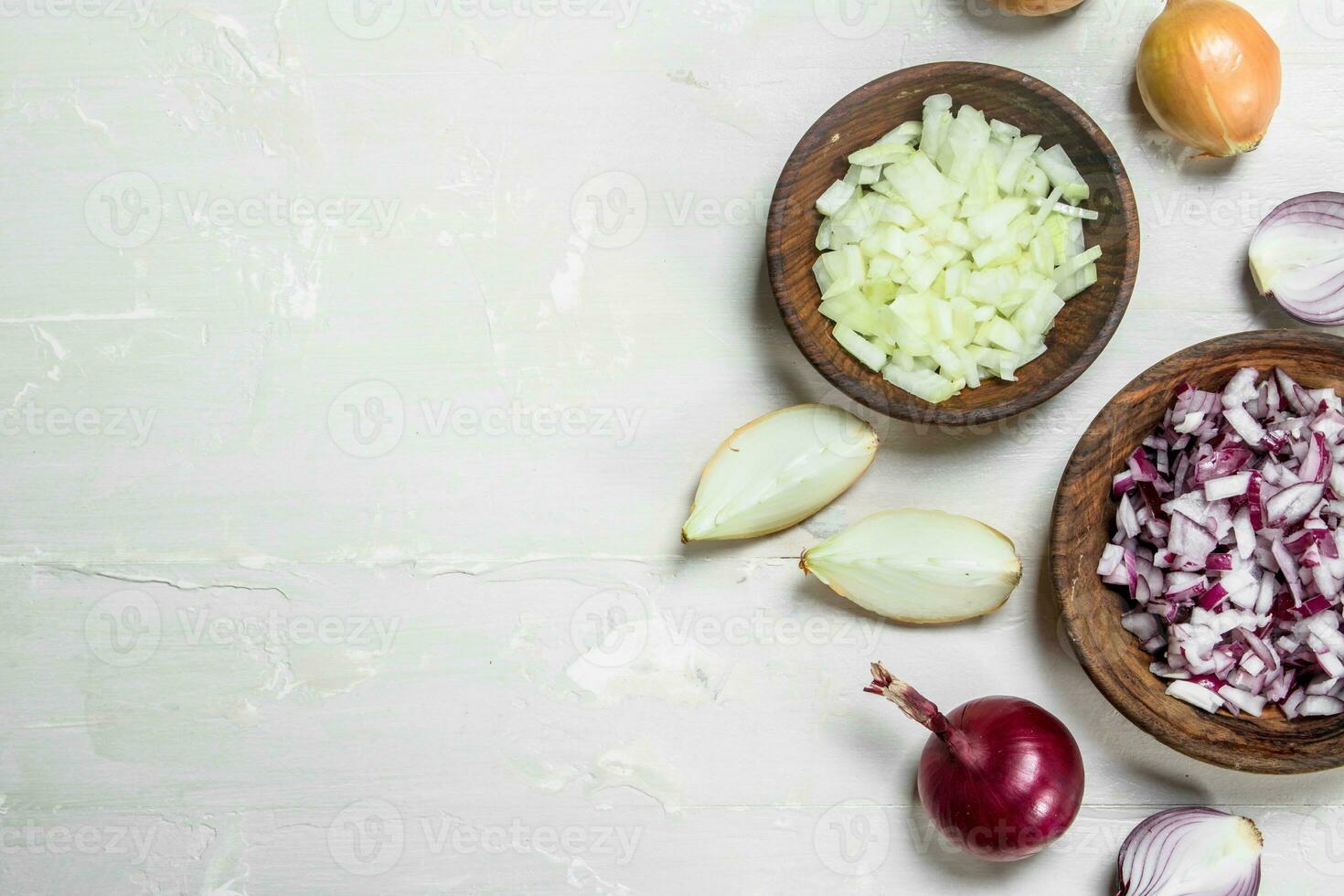 Chopped red and yellow onions in a bowl. photo