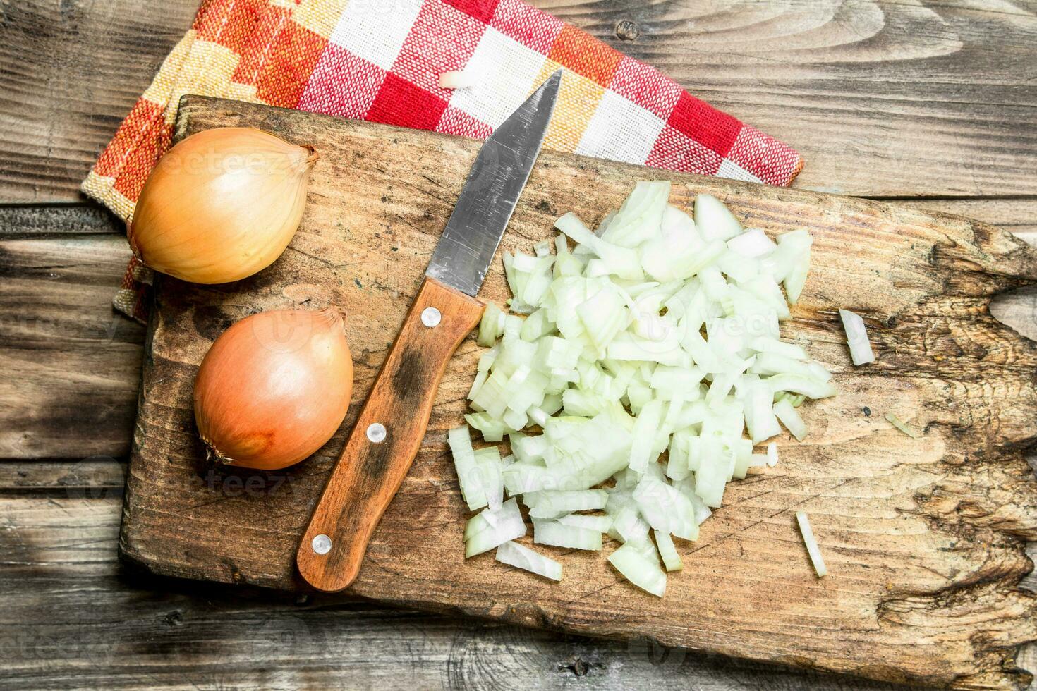 Sliced onions on a cutting Board with a knife on a napkin. photo