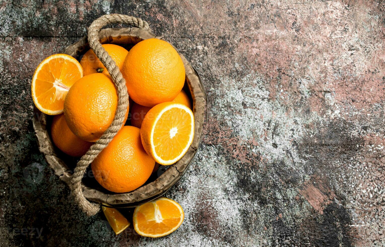 Fresh oranges in an old bucket. photo