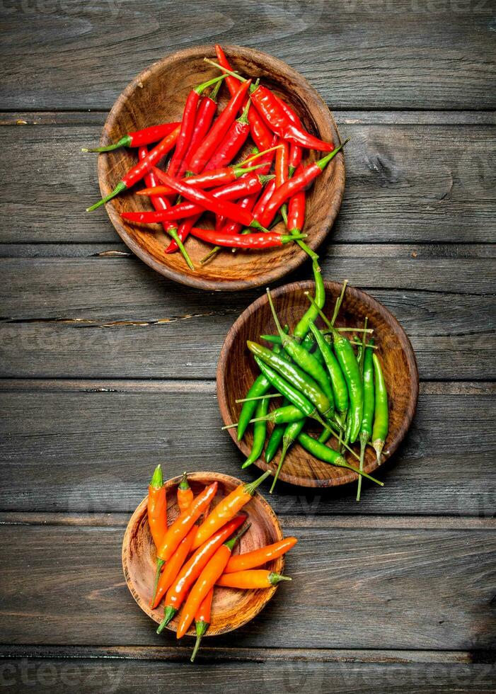 Red, green, orange pepper in bowl. photo