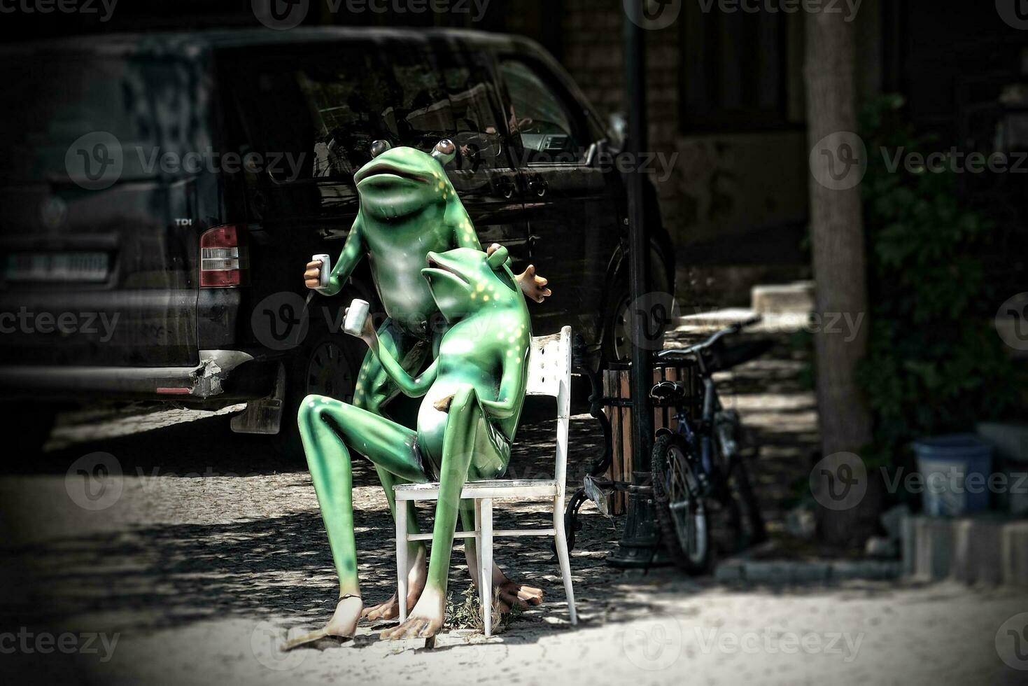 statue of green frogs drinking turkish tea in the city photo