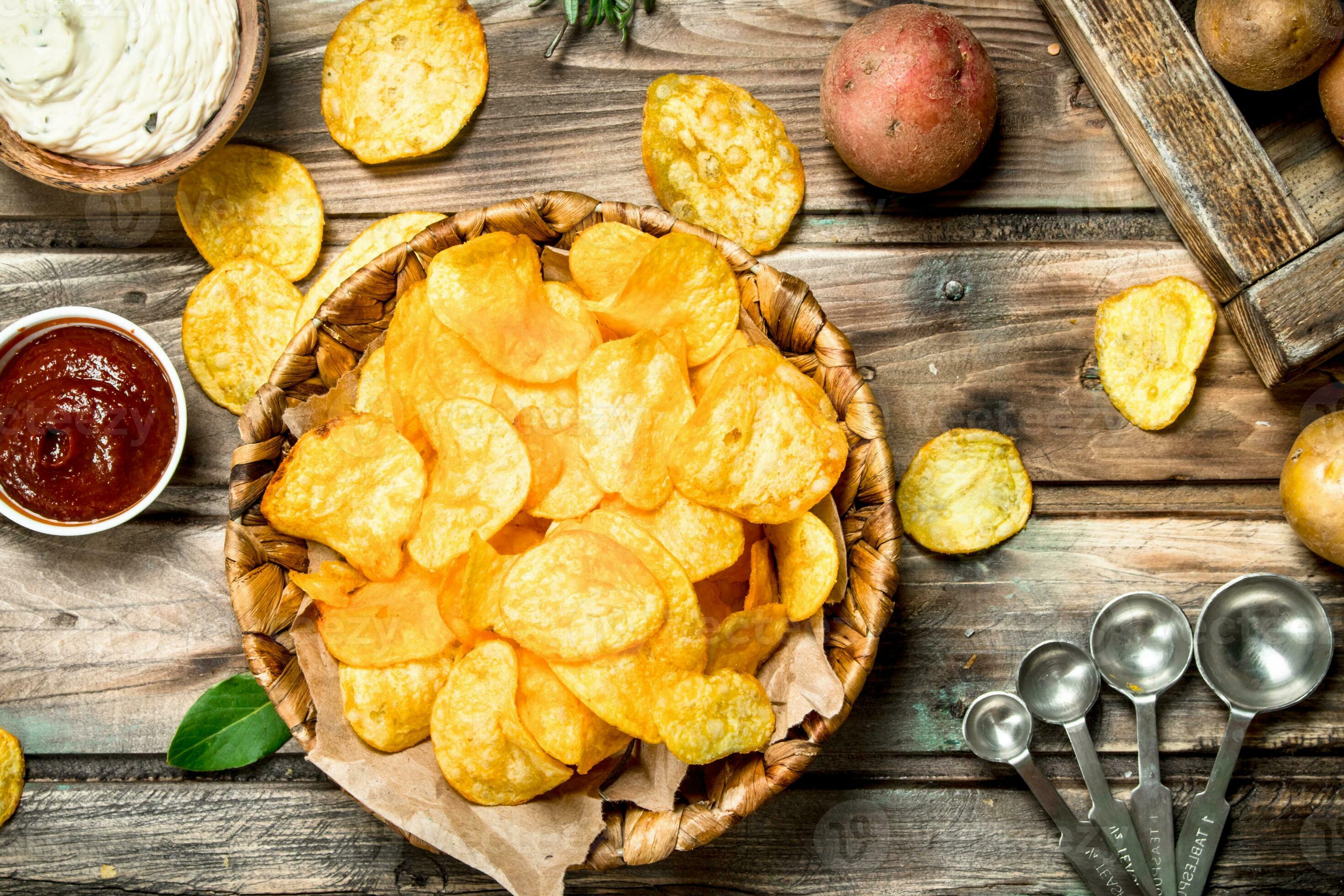 Potato chips in a basket with different sauces. 32008892 Stock Photo at