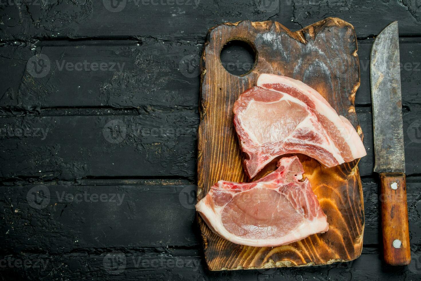 Raw pork steaks on the bone. photo