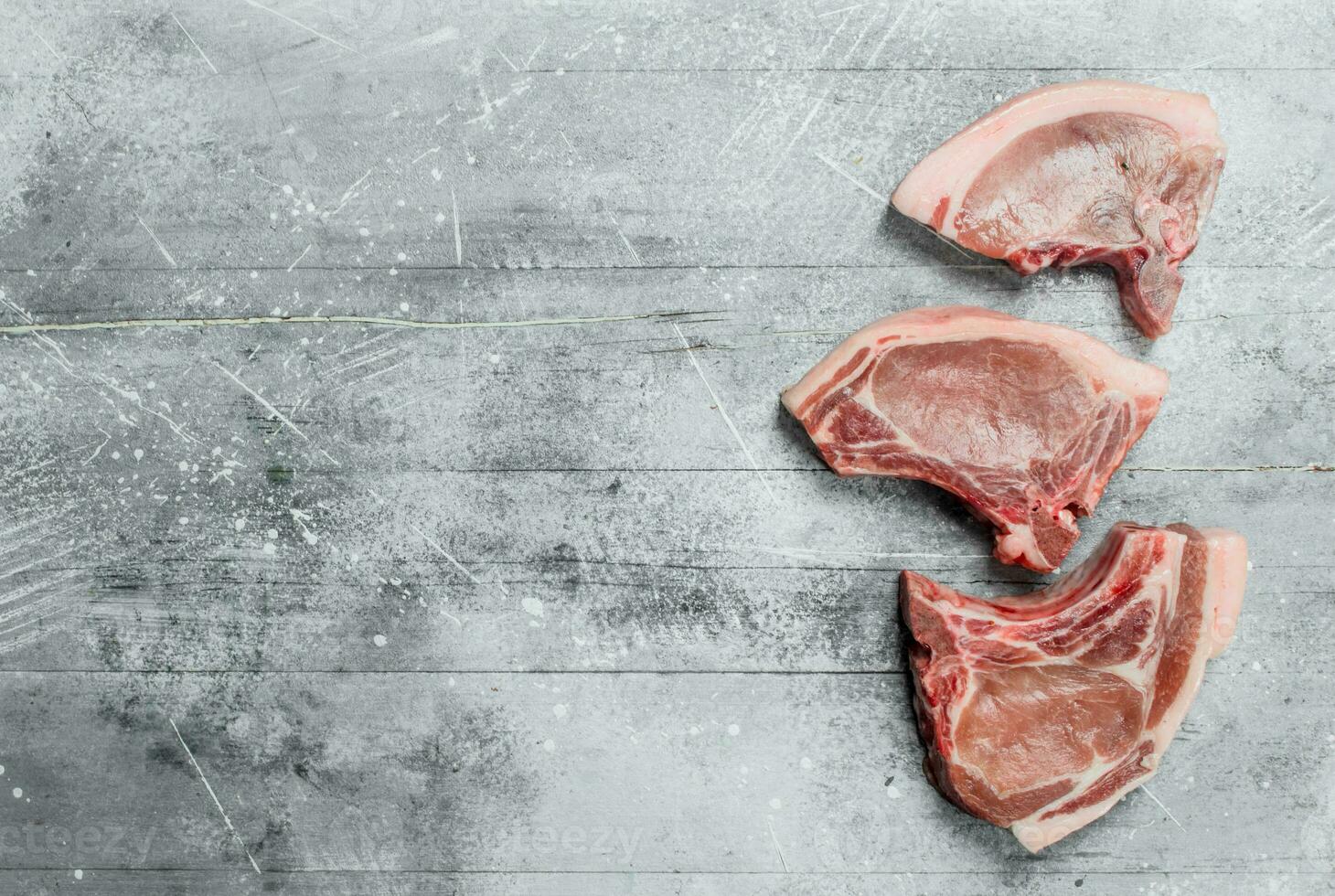 Raw pork steaks on the bone. photo