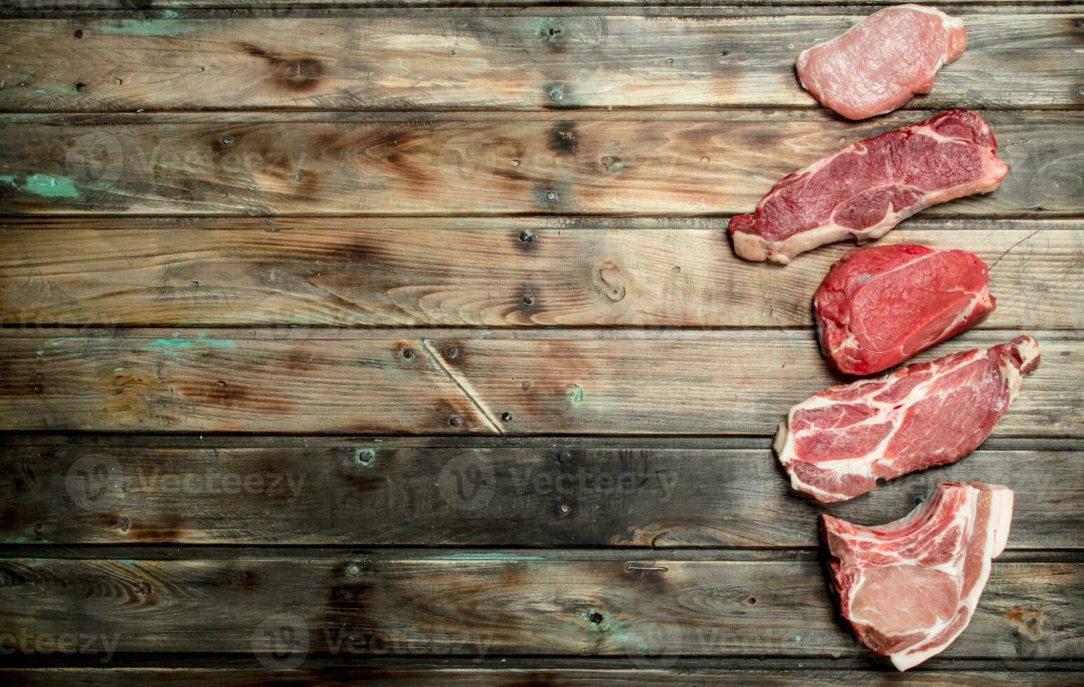 Raw meat. Pork and beef steaks. photo