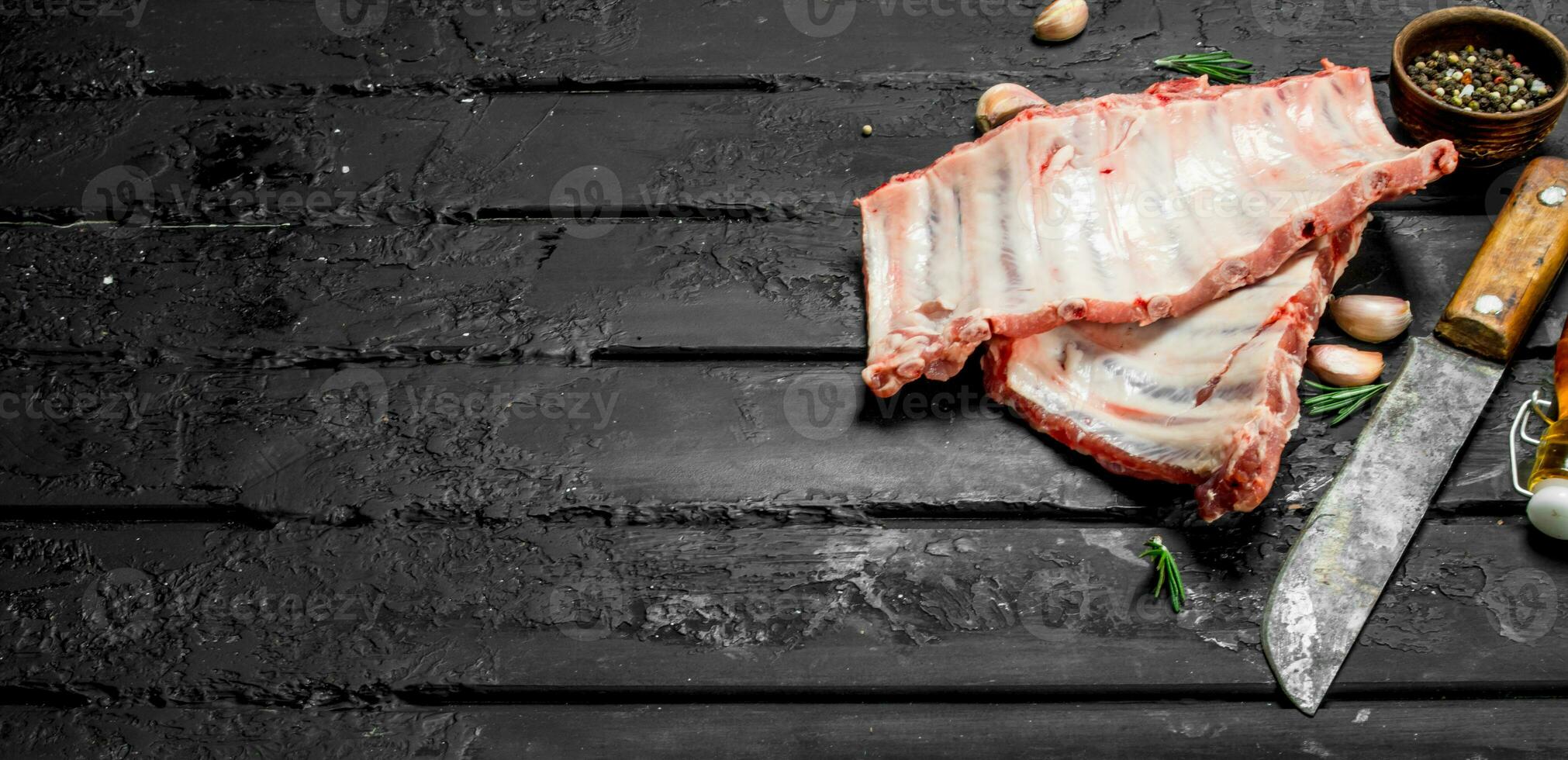 Raw ribs with old hatchet . photo