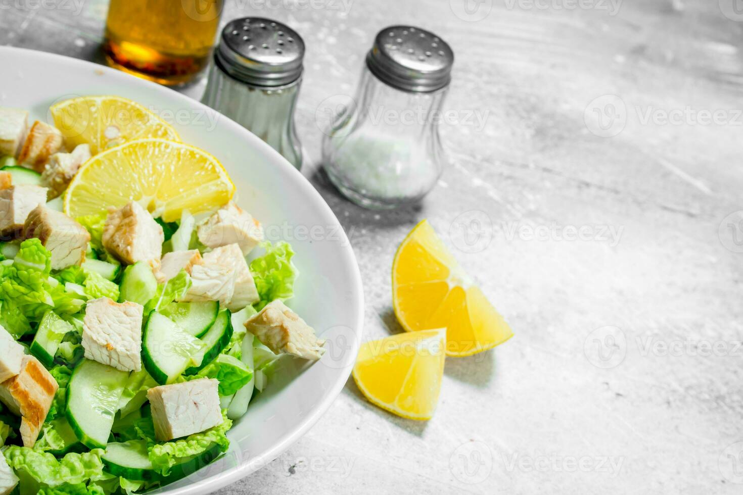 Healthy salad. Salad with cucumbers, chicken and Chinese cabbage poured lemon juice . photo