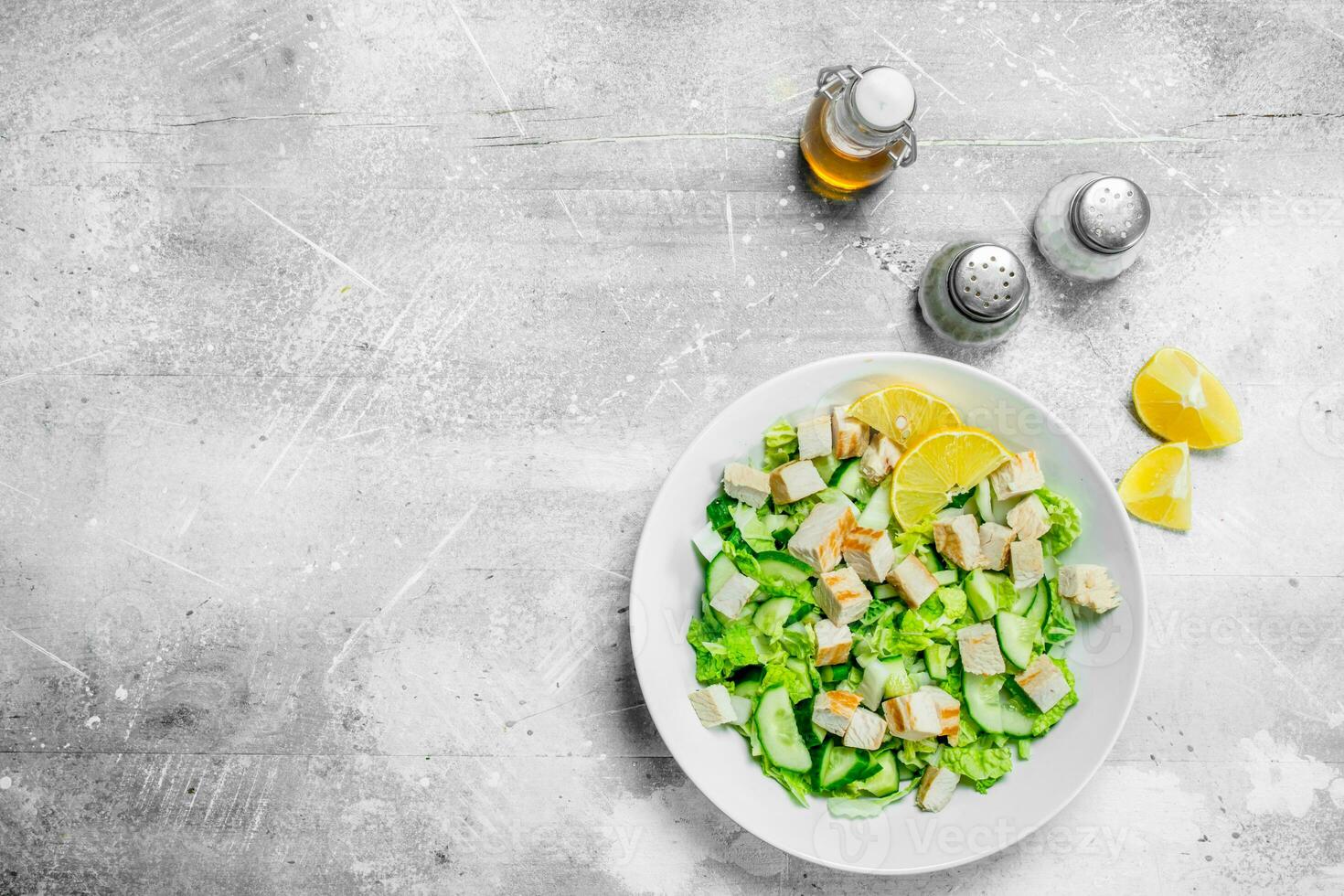 Healthy salad. Salad with cucumbers, chicken and Chinese cabbage poured lemon juice . photo