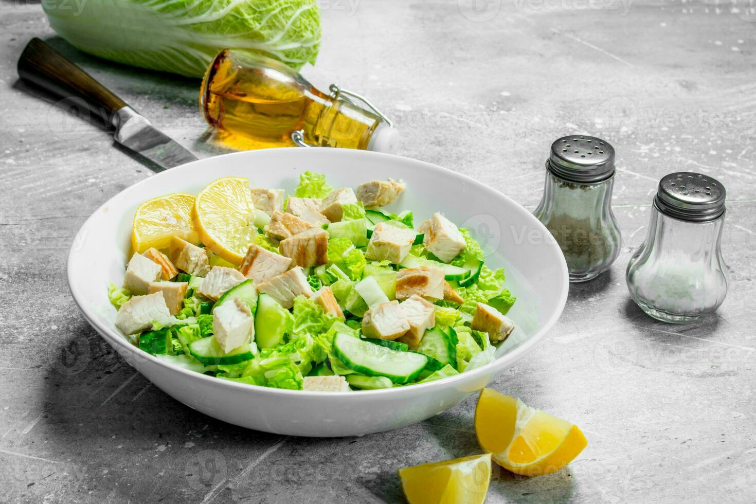 Healthy salad. Salad with cucumbers, chicken and Chinese cabbage poured lemon juice . photo